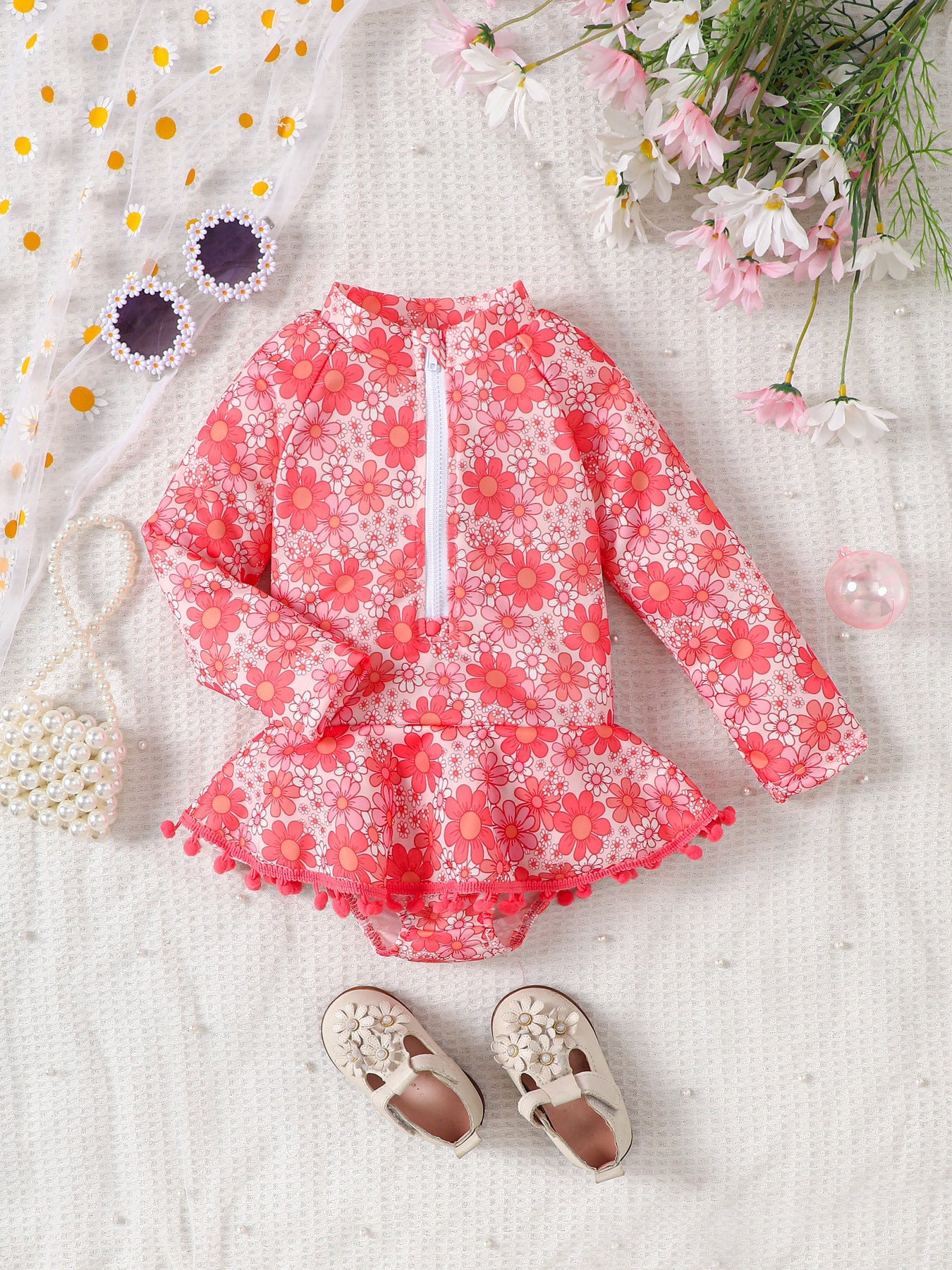 Girls' Long Sleeve Daisy Print Rash Guard Swimsuit with Pom-Pom Ruffle Skirt – Sizes 18 Months–6 Years