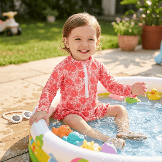 Girls' Long Sleeve Daisy Print Rash Guard Swimsuit with Pom-Pom Ruffle Skirt – Sizes 18 Months–6 Years