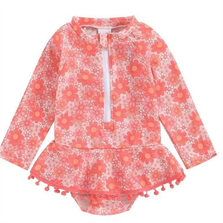 Girls' Long Sleeve Daisy Print Rash Guard Swimsuit with Pom-Pom Ruffle Skirt – Sizes 18 Months–6 Years